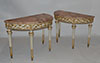 Pair of Italian, Neoclassical, white-painted and parcel-gilt demi-lune console tables